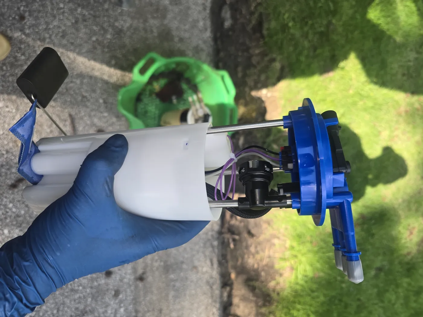 New fuel pump module held in a gloved hand before going into the tank